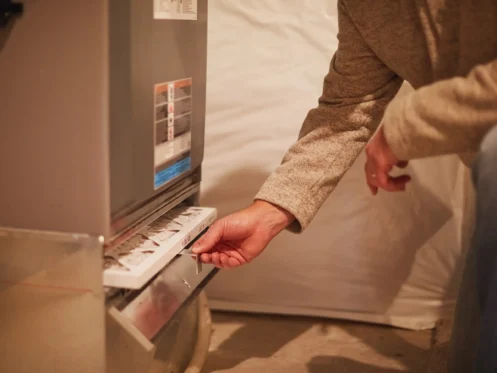 Person changing HVAC system air filter