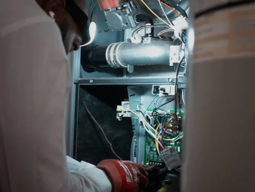 Technician repairing gas furnace system