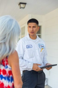 hvac service technician talking to customer