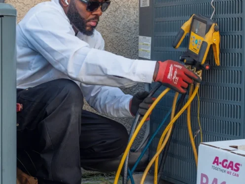 Polar Express technician checking refrigerant levels of AC unit