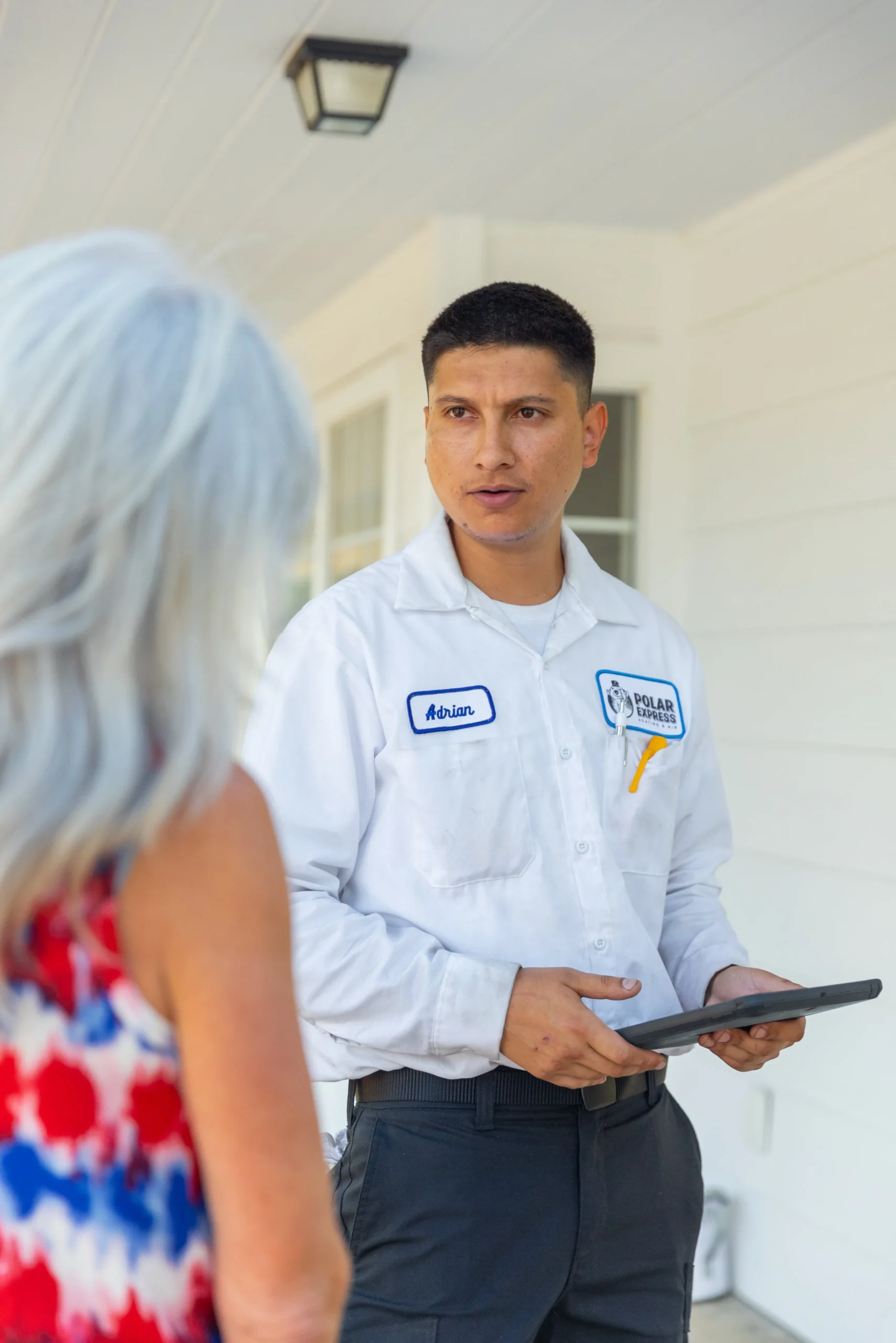 hvac service technician talking to customer
