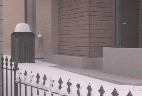 HVAC outdoor unit covered with snow during winter