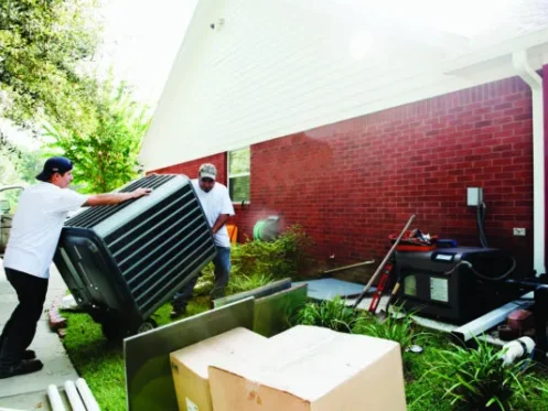 Technicians installing new air conditioning unit